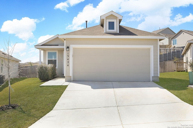 view of front of property featuring an attached garage, fence, concrete driveway, and a front yard