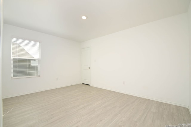 unfurnished room with light wood-type flooring, baseboards, and recessed lighting