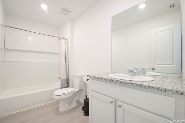 bathroom with toilet, shower / bath combo with shower curtain, vanity, and visible vents