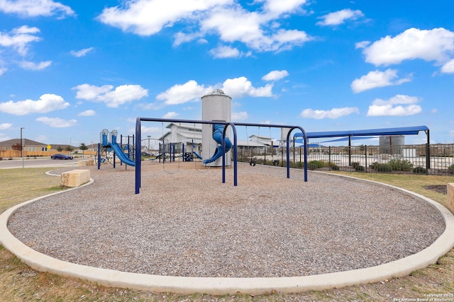 community jungle gym featuring fence