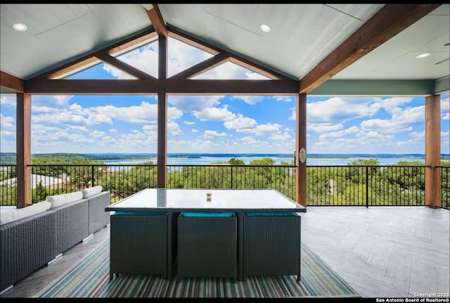 wooden deck with a water view and an outdoor hangout area