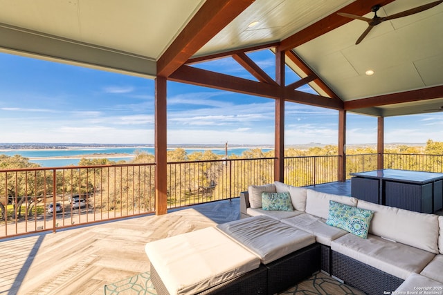 view of patio / terrace featuring a water view, ceiling fan, and an outdoor living space