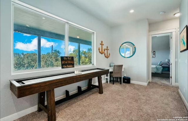 game room with light carpet and baseboards