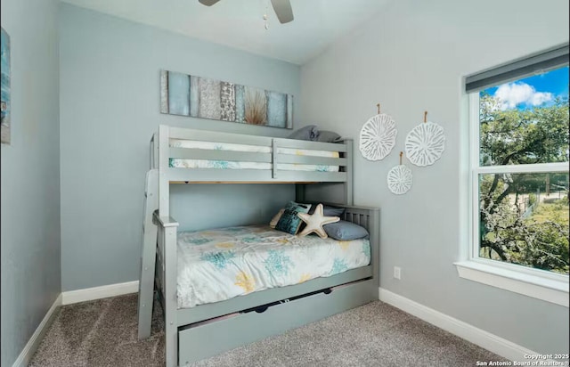 bedroom featuring carpet floors, multiple windows, and baseboards