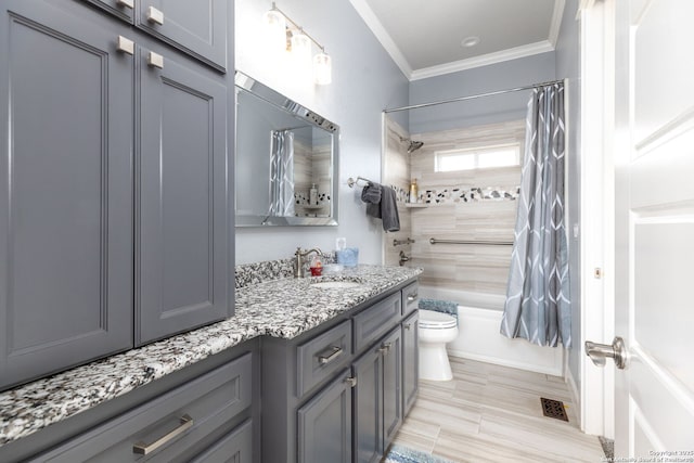 bathroom with visible vents, toilet, ornamental molding, shower / bathtub combination with curtain, and vanity