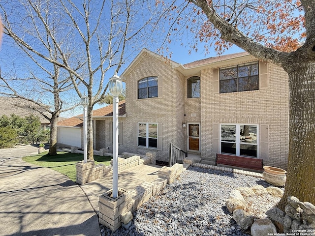 traditional-style home featuring entry steps and brick siding