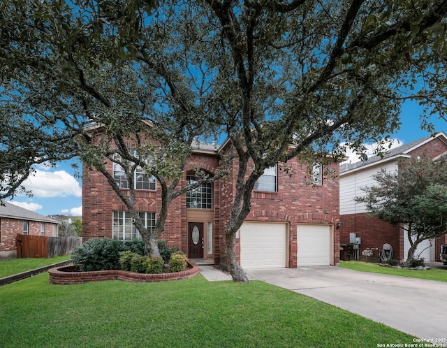 view of front of home with brick siding, concrete driveway, an attached garage, fence, and a front yard