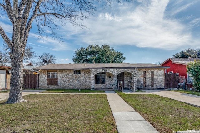 single story home featuring a front yard and fence