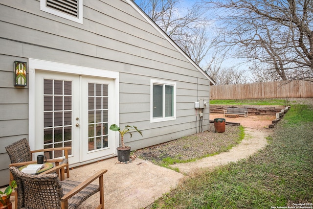 exterior space with fence and french doors