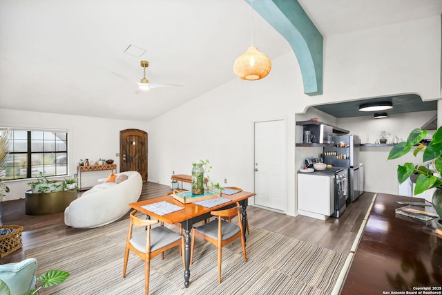 dining space with vaulted ceiling, ceiling fan, and wood finished floors