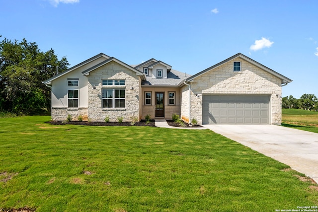 view of front of home with an attached garage, driveway, and a front yard