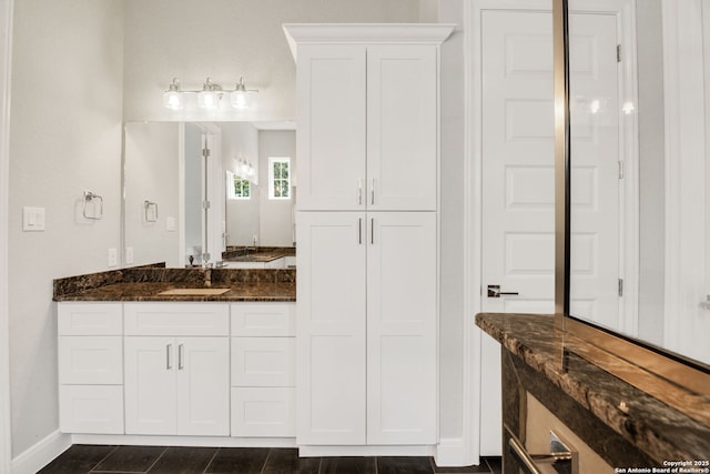 full bathroom with baseboards and vanity