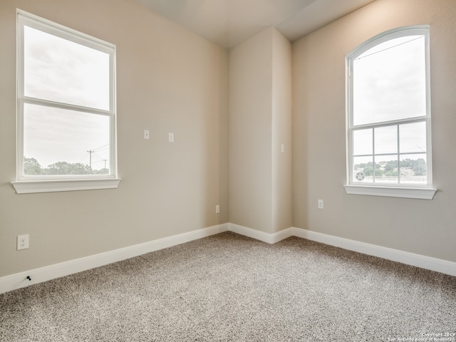 empty room with carpet and baseboards