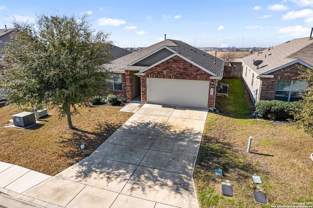 view of front of house with brick siding, a shingled roof, concrete driveway, a front yard, and a garage