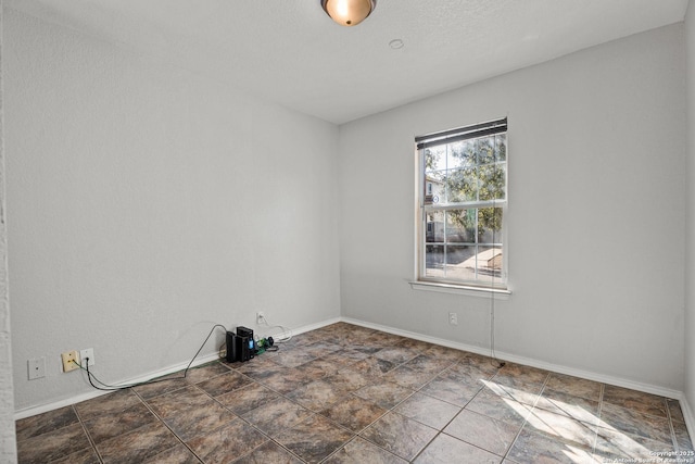 unfurnished room featuring baseboards