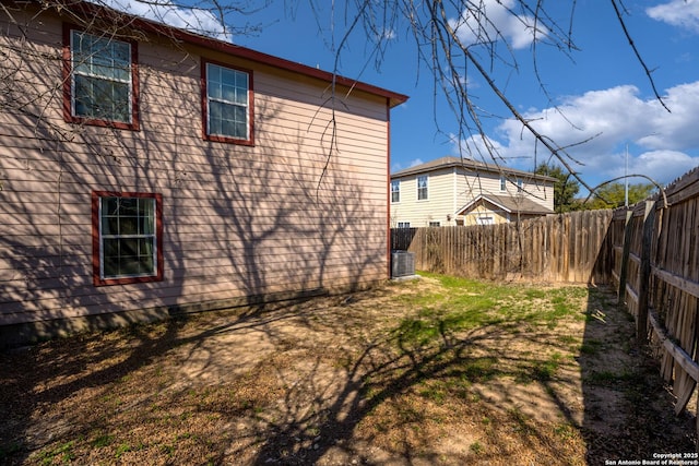 view of side of home featuring a fenced backyard