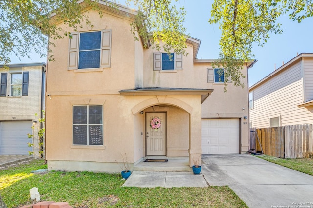 view of front facade featuring concrete driveway, fence, an attached garage, and stucco siding