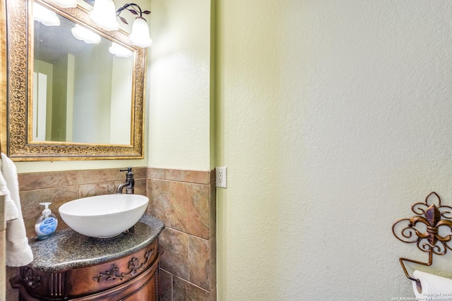 bathroom featuring tile walls and vanity