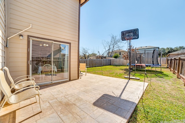 view of patio / terrace featuring a trampoline and a fenced backyard