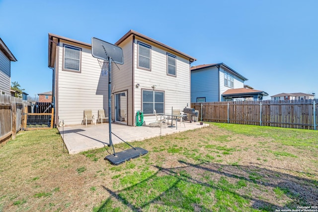 back of house with a patio, a lawn, and a fenced backyard