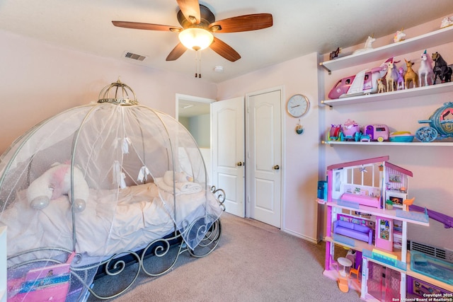 carpeted bedroom with visible vents and a ceiling fan