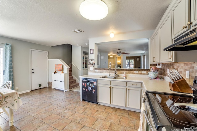 kitchen with stainless steel electric range oven, light countertops, a sink, dishwasher, and under cabinet range hood