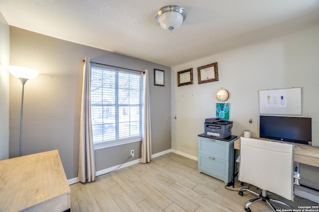 office space featuring light wood finished floors and baseboards