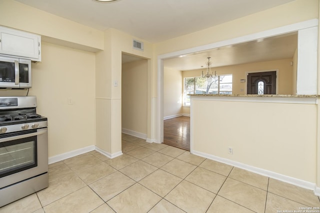 kitchen featuring a chandelier, appliances with stainless steel finishes, light tile patterned floors, and visible vents