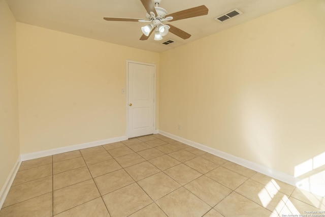 spare room featuring visible vents, ceiling fan, and baseboards