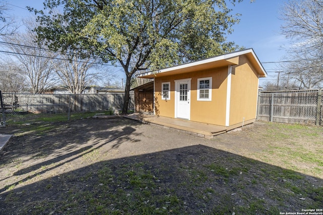 view of outbuilding featuring a fenced backyard and an outbuilding