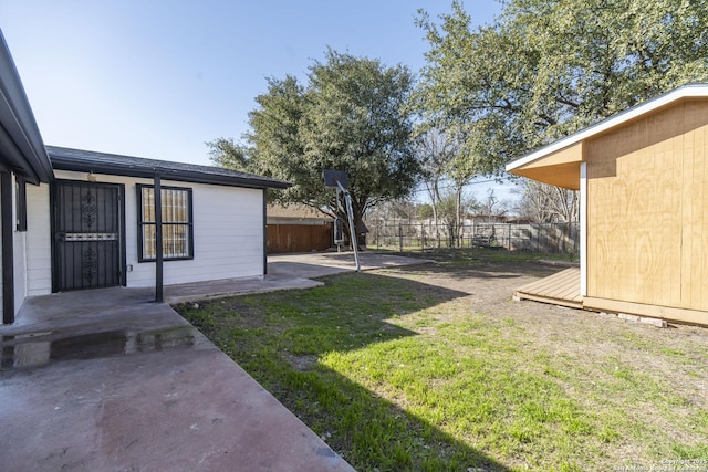 view of yard featuring fence and a patio