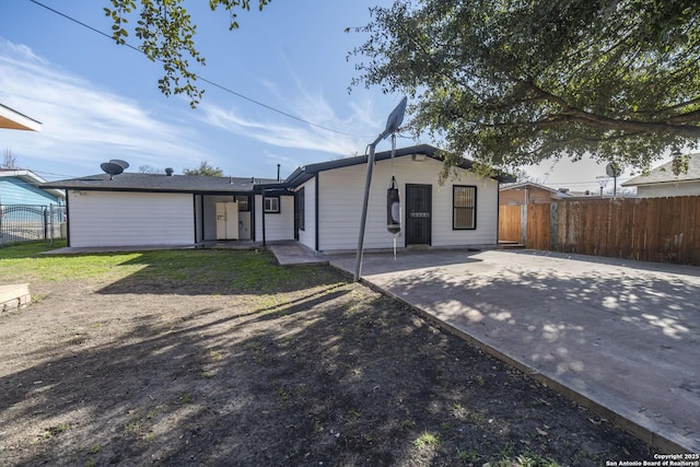 view of front facade featuring fence and a patio