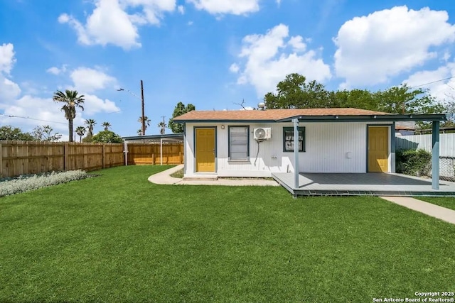 rear view of house featuring a fenced backyard and a yard