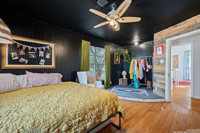 bedroom with visible vents and wood finished floors