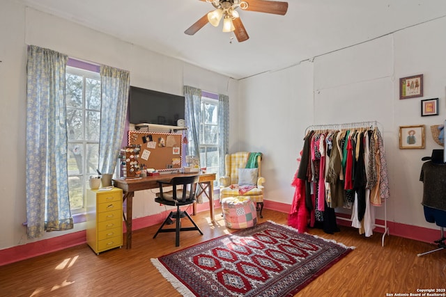 office with wood finished floors, a ceiling fan, and a healthy amount of sunlight