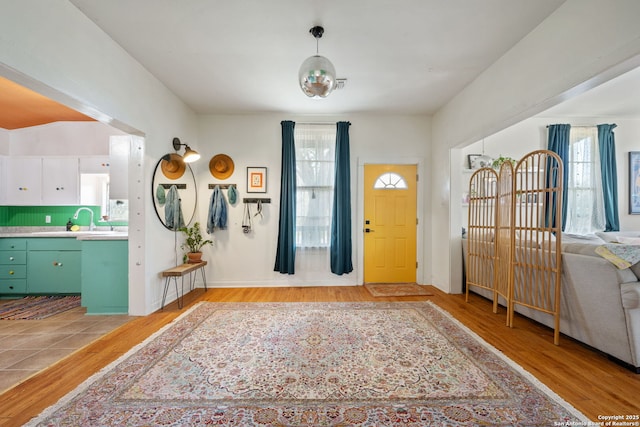 foyer entrance featuring light wood-style flooring and a wealth of natural light