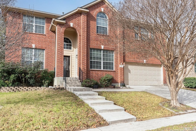 traditional home featuring a front yard, concrete driveway, brick siding, and entry steps