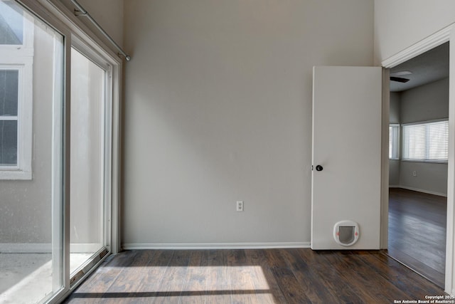 unfurnished room featuring wood finished floors and baseboards