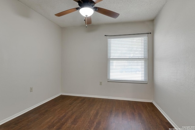 unfurnished room featuring baseboards, dark wood-style floors, and a ceiling fan