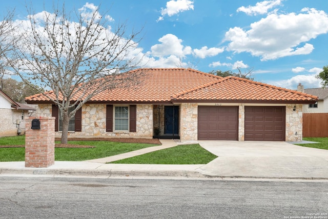 view of front facade with an attached garage, fence, a tiled roof, concrete driveway, and a front yard