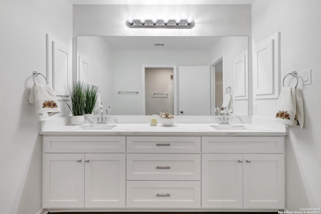 full bath featuring double vanity, a sink, and visible vents