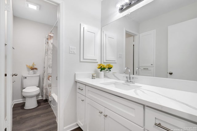 full bath with toilet, baseboards, wood finished floors, and vanity