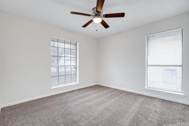 spare room with ceiling fan, baseboards, and carpet flooring