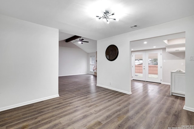 spare room featuring plenty of natural light, dark wood finished floors, and visible vents