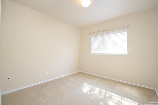 spare room with baseboards and carpet flooring