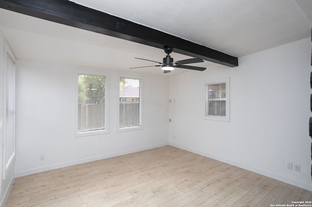 unfurnished room with beamed ceiling, wood finished floors, a ceiling fan, and baseboards