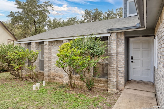 entrance to property featuring brick siding