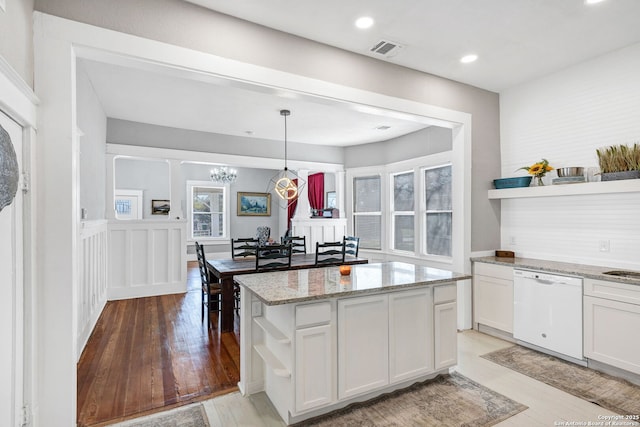 kitchen featuring white cabinets, light stone counters, white dishwasher, light wood-type flooring, and open shelves