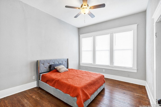 bedroom featuring a ceiling fan, baseboards, and hardwood / wood-style floors