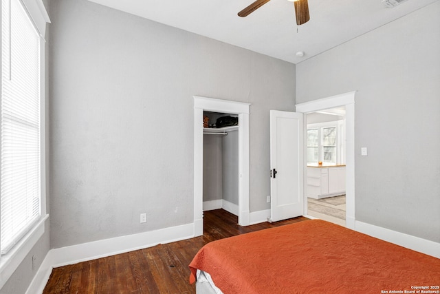 bedroom with baseboards, visible vents, ceiling fan, wood finished floors, and a closet